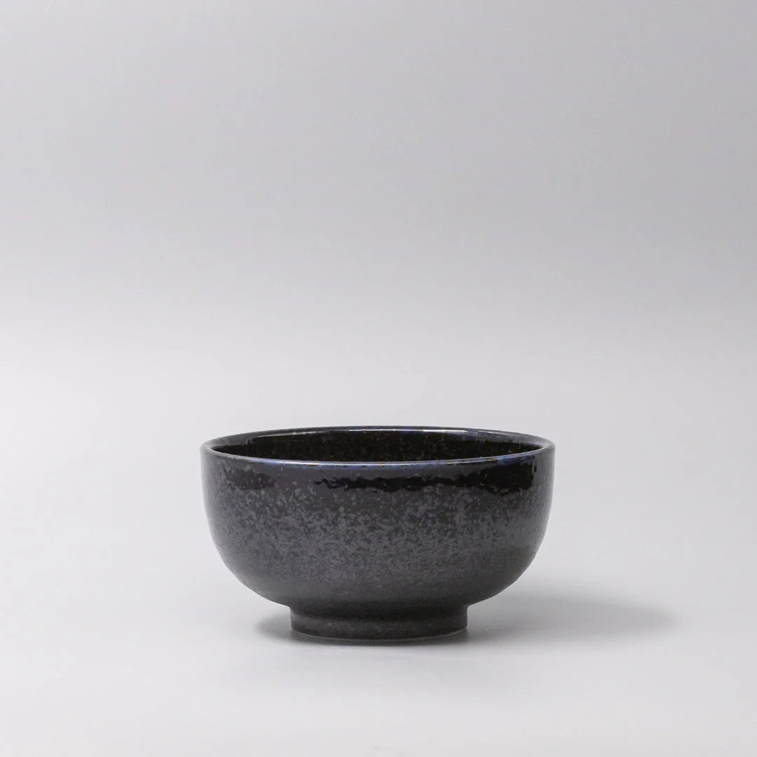Black ceramic bowl on a light gray background
