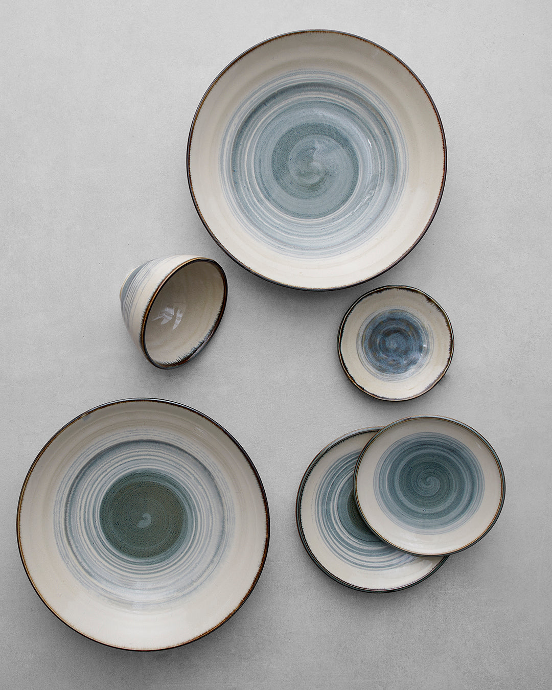 Set of ceramic bowls with concentric circle patterns on a light gray background