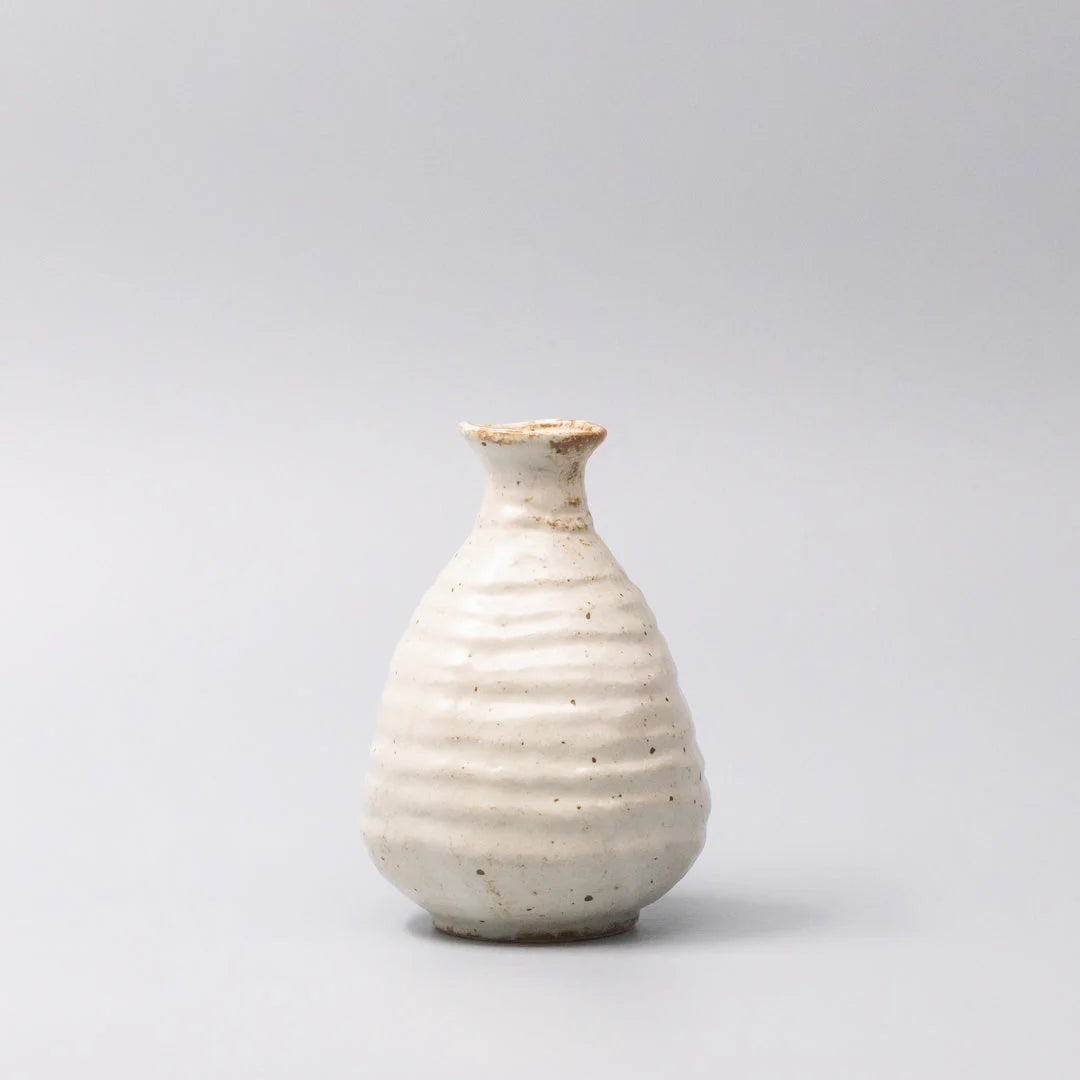 White ceramic vase on a light gray background