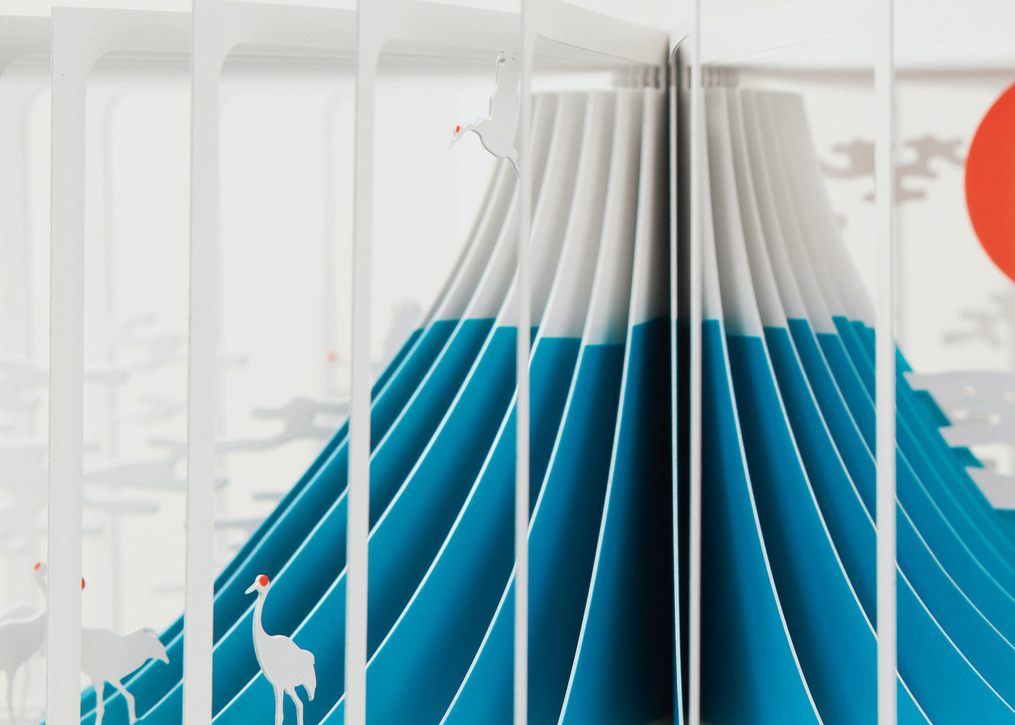 Open book with a design of a blue wave and a red circle on a white background