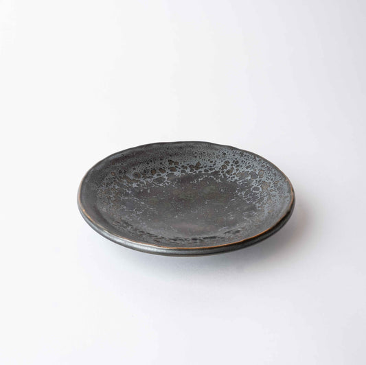 Black ceramic plate on a white background