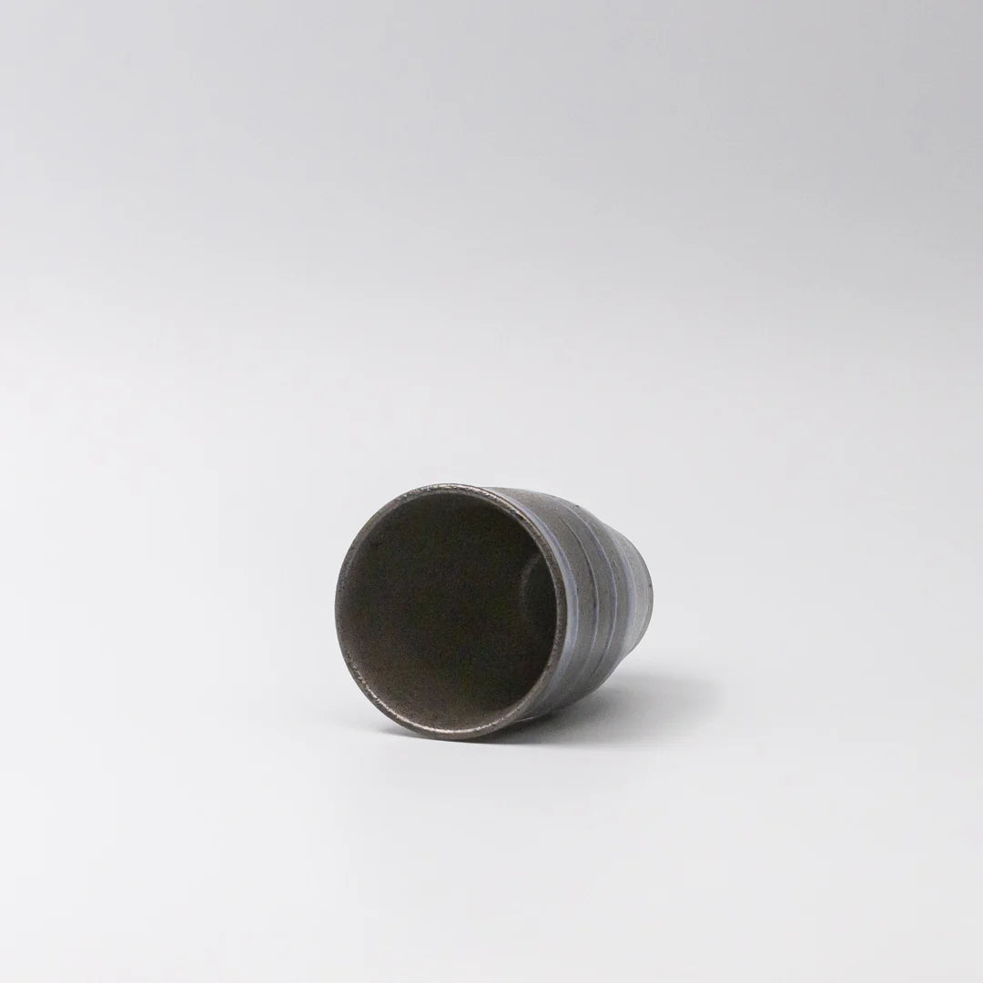 Cylindrical ceramic cup on a white background