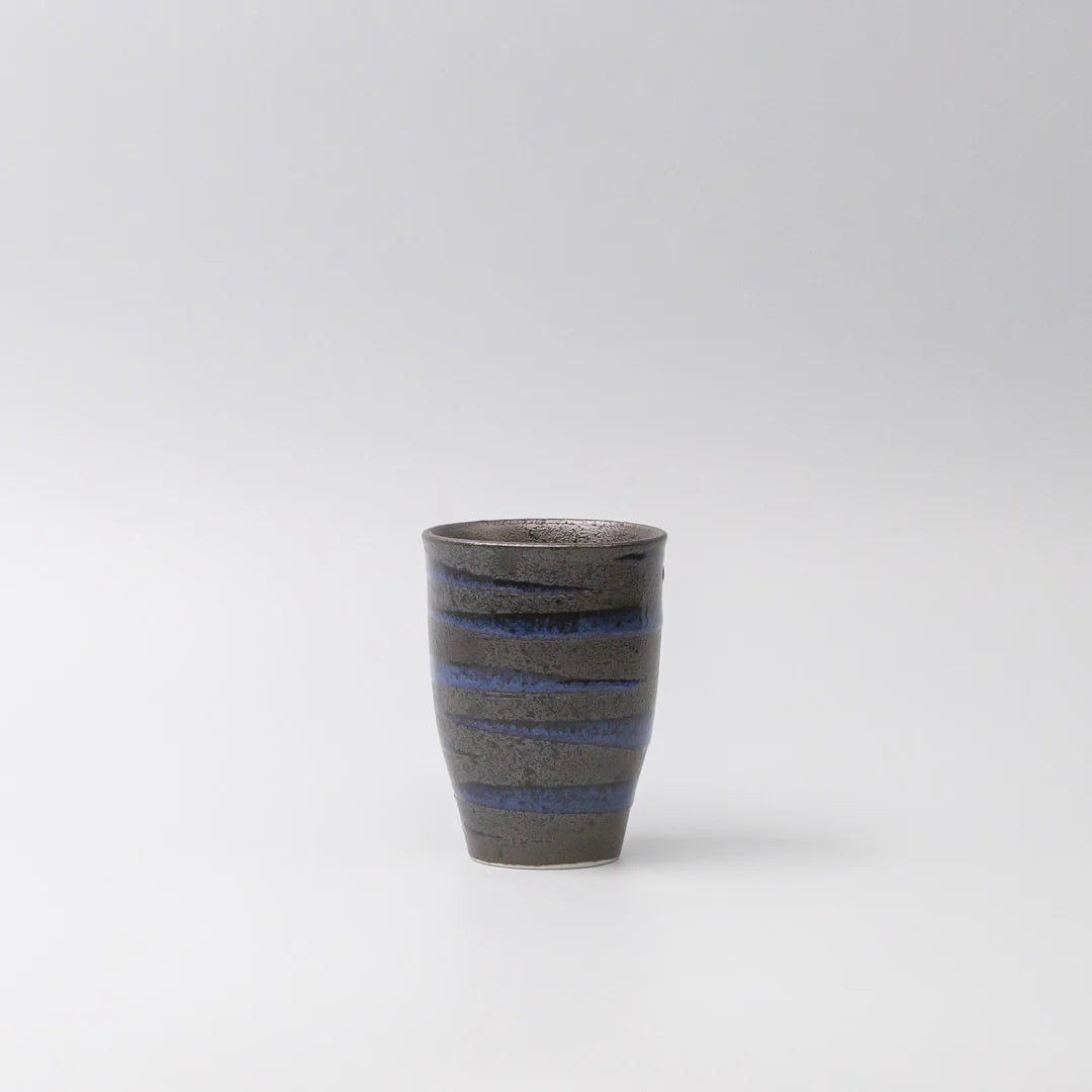 Ceramic cup with blue stripes on a white background