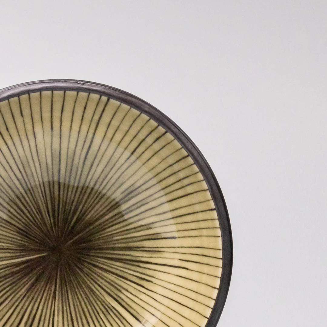 Close-up of a ceramic bowl with a textured surface on a light gray background