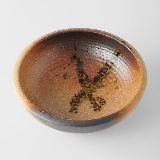Ceramic bowl with a textured surface on a light gray background