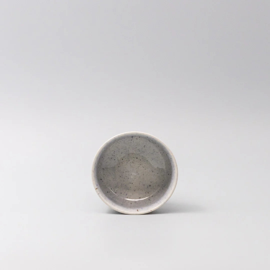 Small ceramic bowl with a speckled gray finish on a light gray background