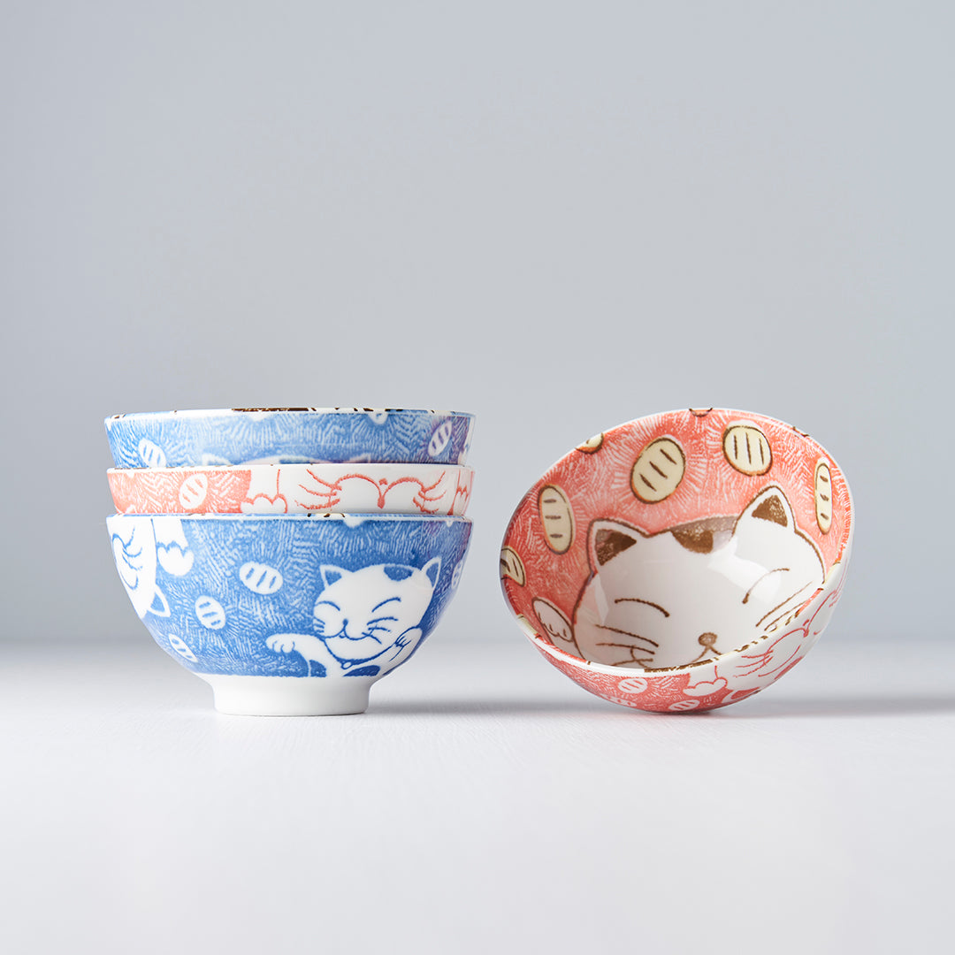 Set of ceramic bowls with cat designs on a light gray background