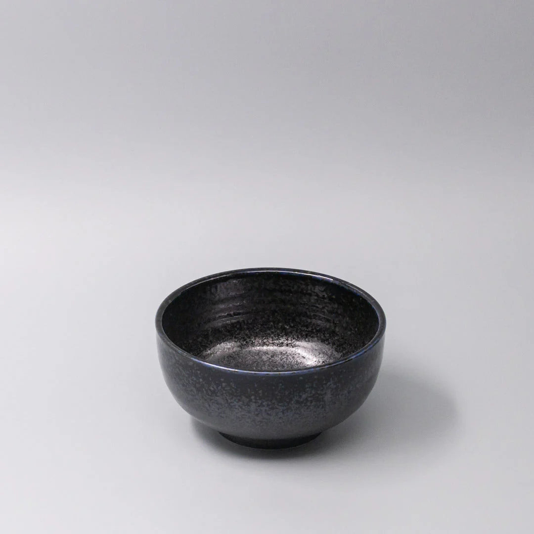 Black ceramic bowl on a light gray background