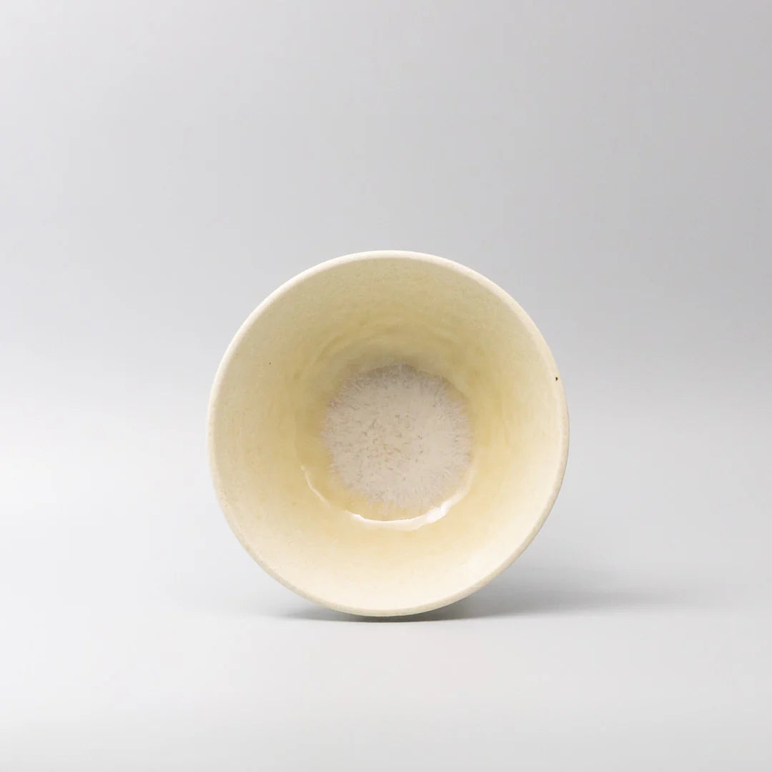 Yellow ceramic bowl on a light gray background