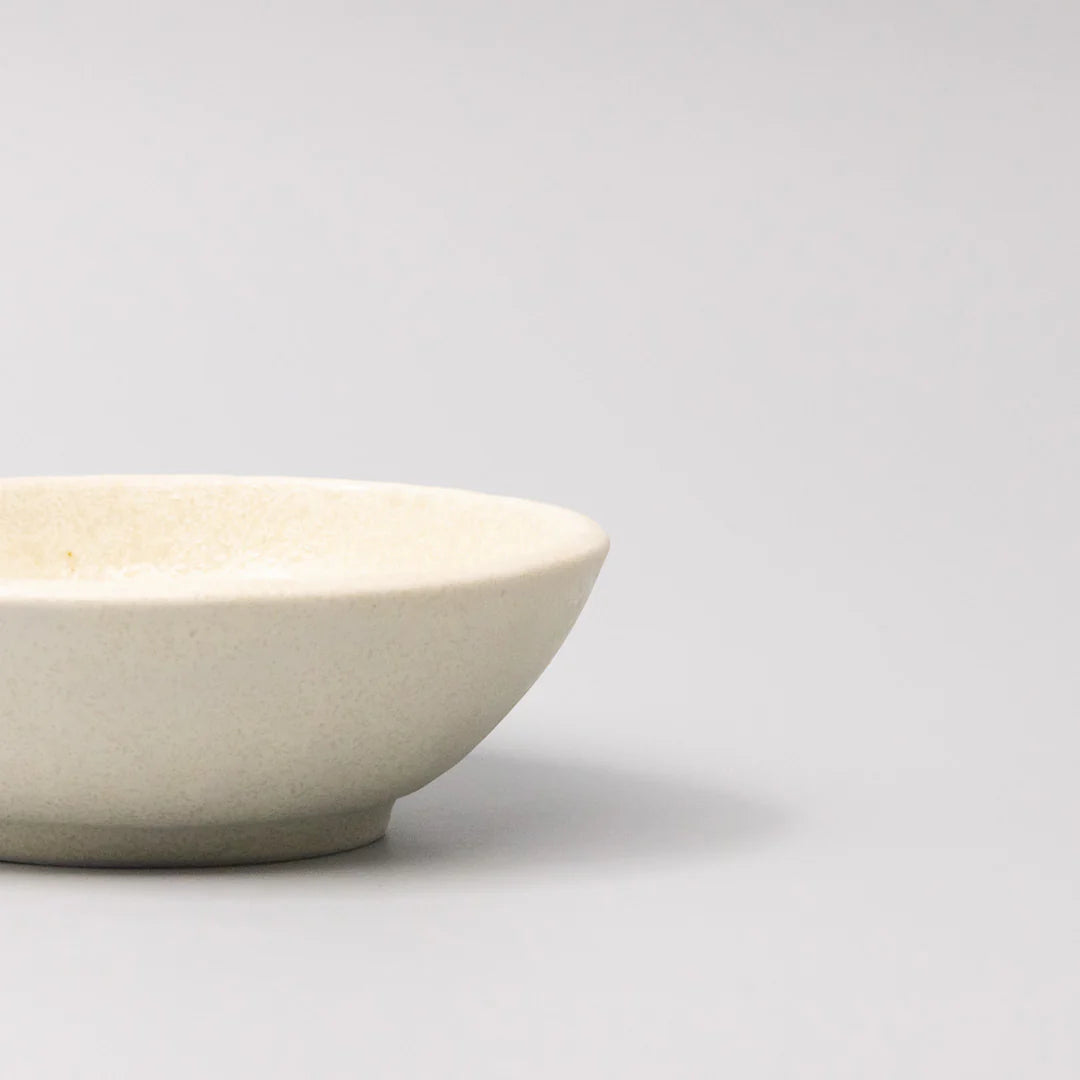 White ceramic bowl on a light gray background