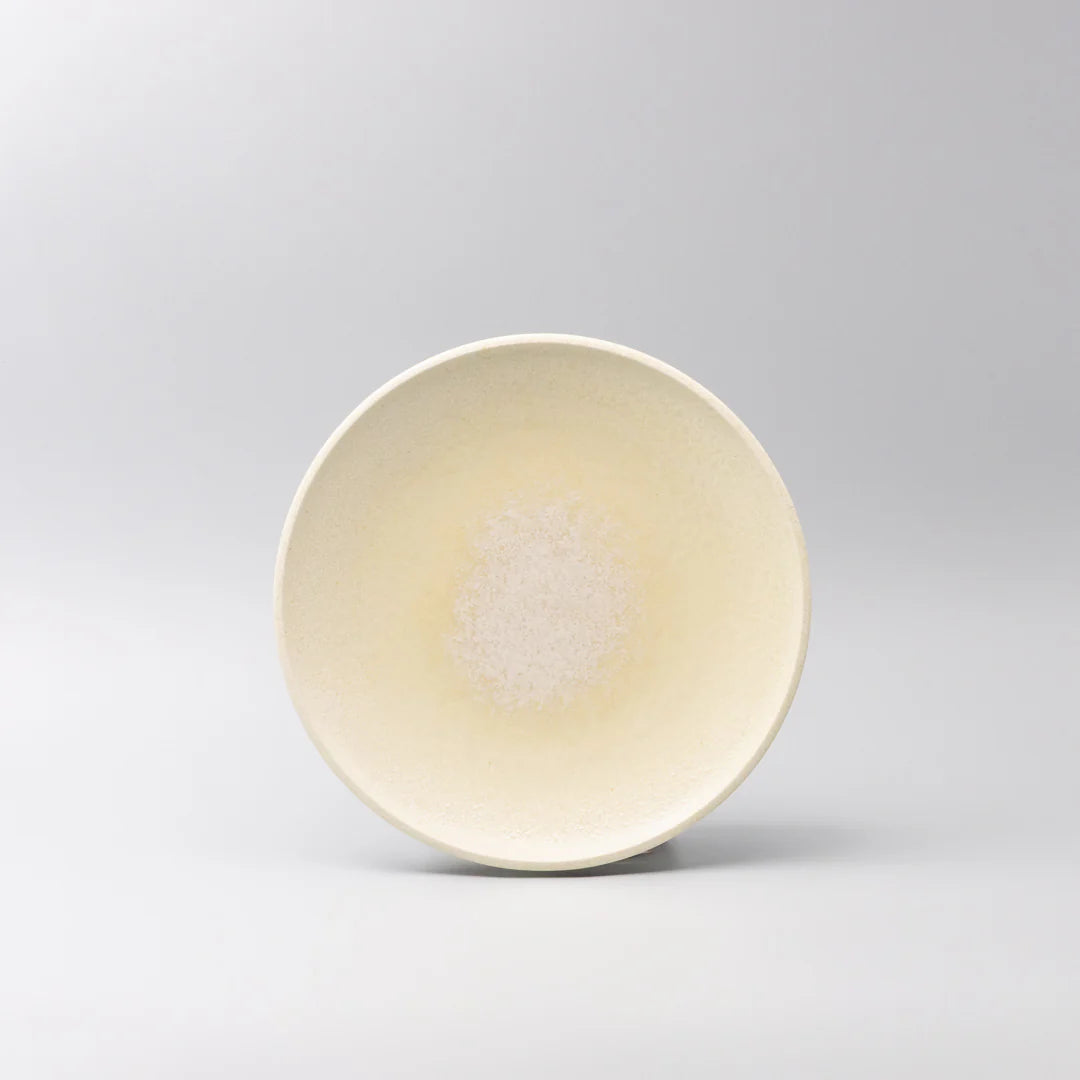 Beige ceramic bowl on a light gray background