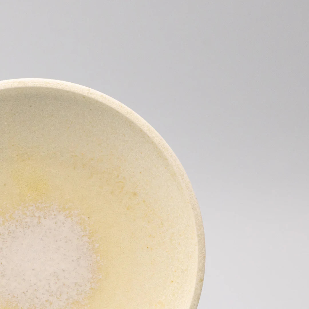 Close-up of a ceramic bowl with a gradient color on a gray background