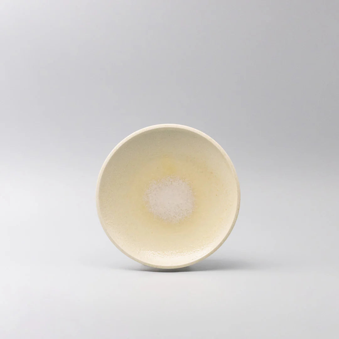 Ceramic bowl with a subtle pattern on a light gray background