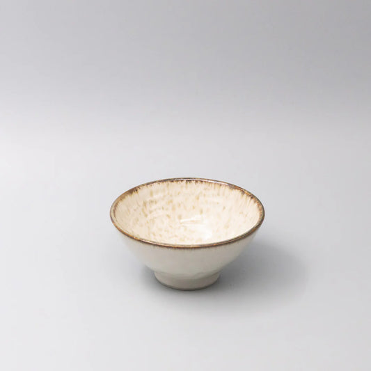 Small ceramic bowl with a textured surface on a light gray background