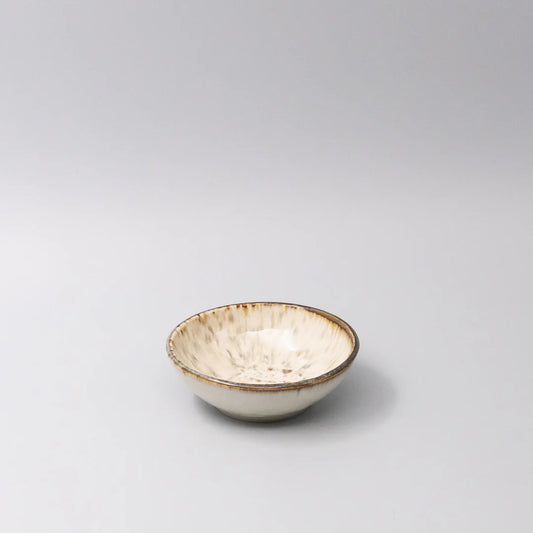 Small ceramic bowl with a textured surface on a gray background