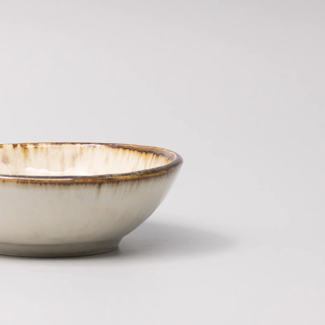 Ceramic bowl with a rustic finish on a light gray background
