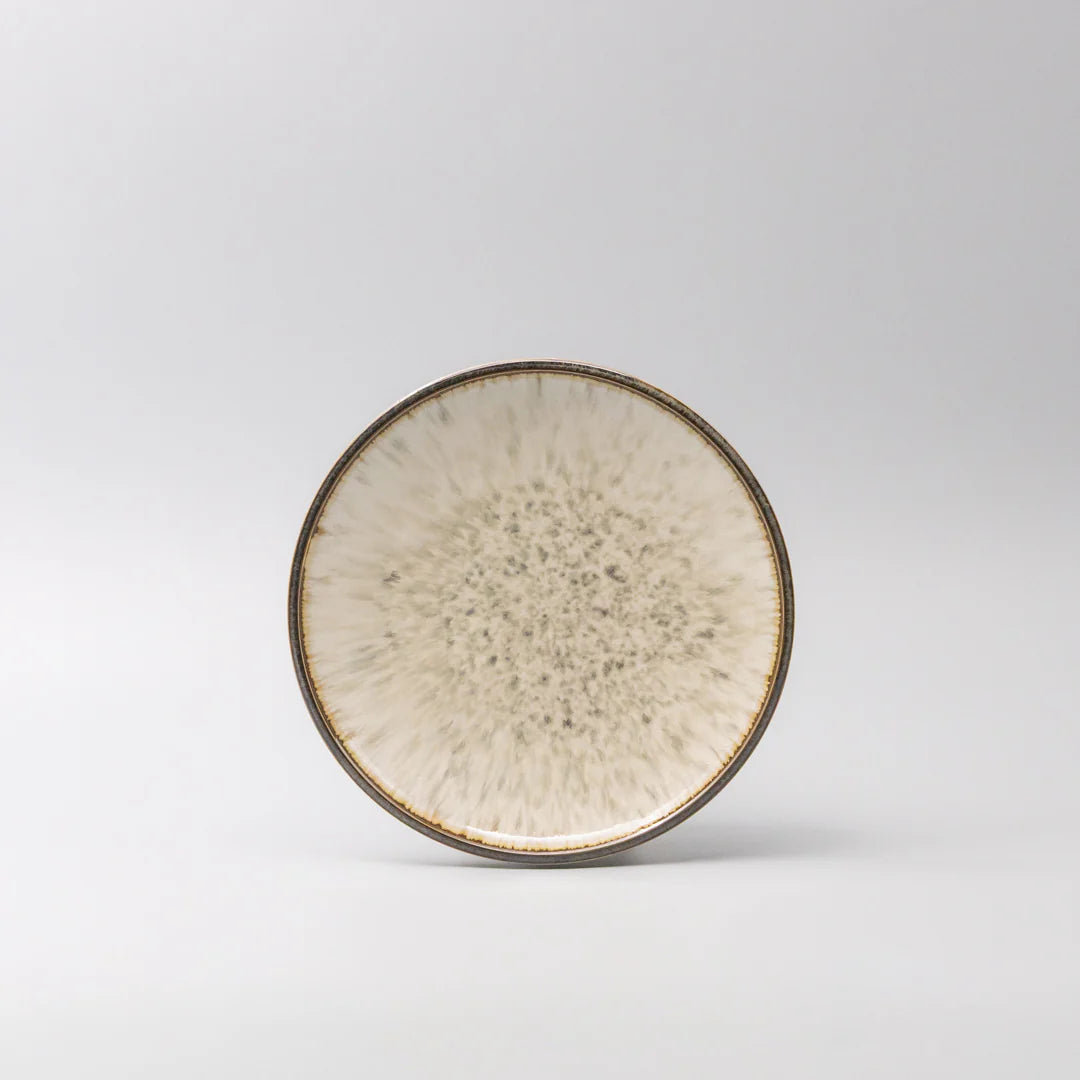 Ceramic plate with textured surface on a light gray background