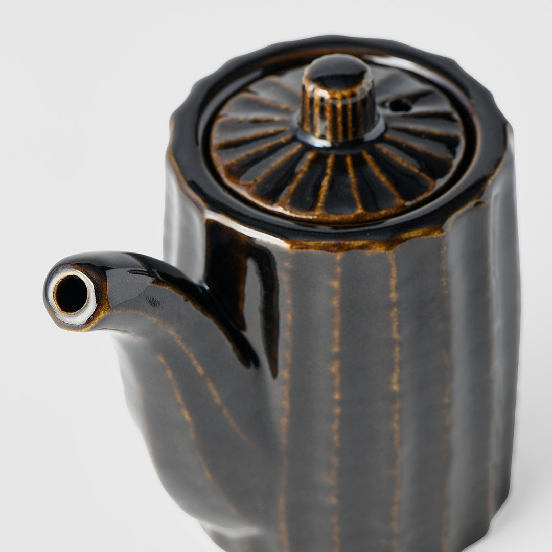 Black ceramic teapot with decorative lid on a white background