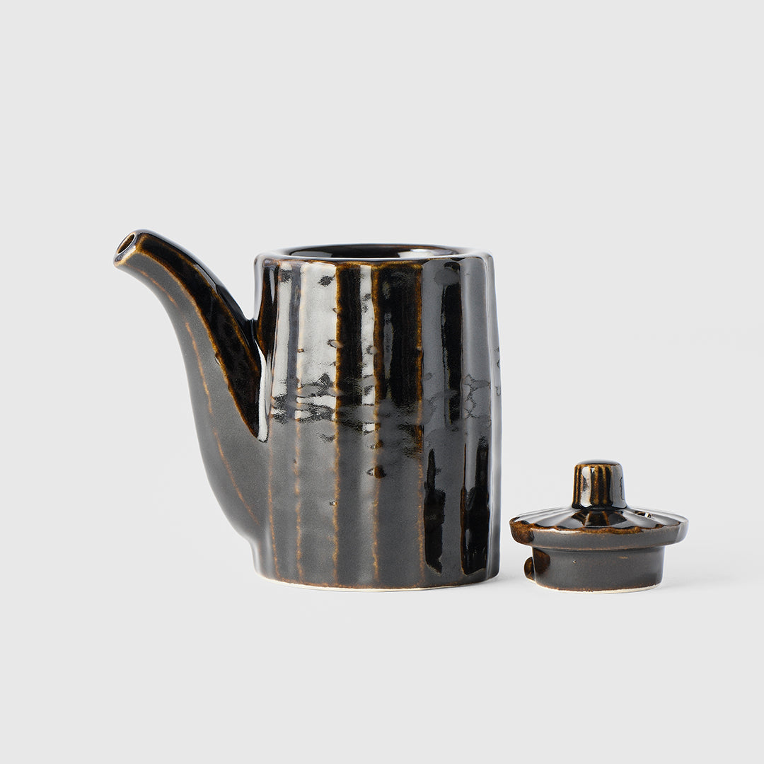 Black ceramic teapot with lid on a white background