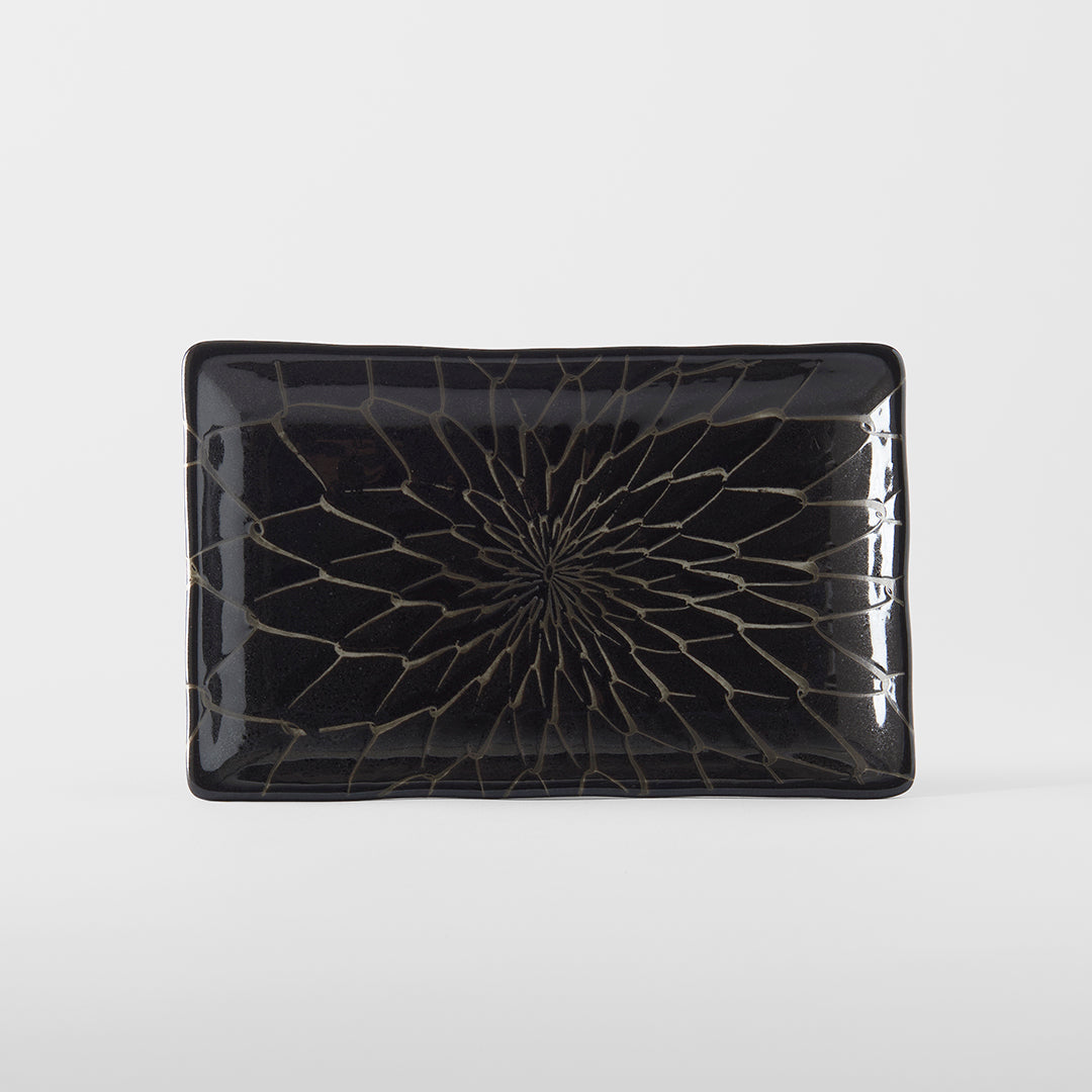 Black rectangular plate with a cracked glass design on a white background