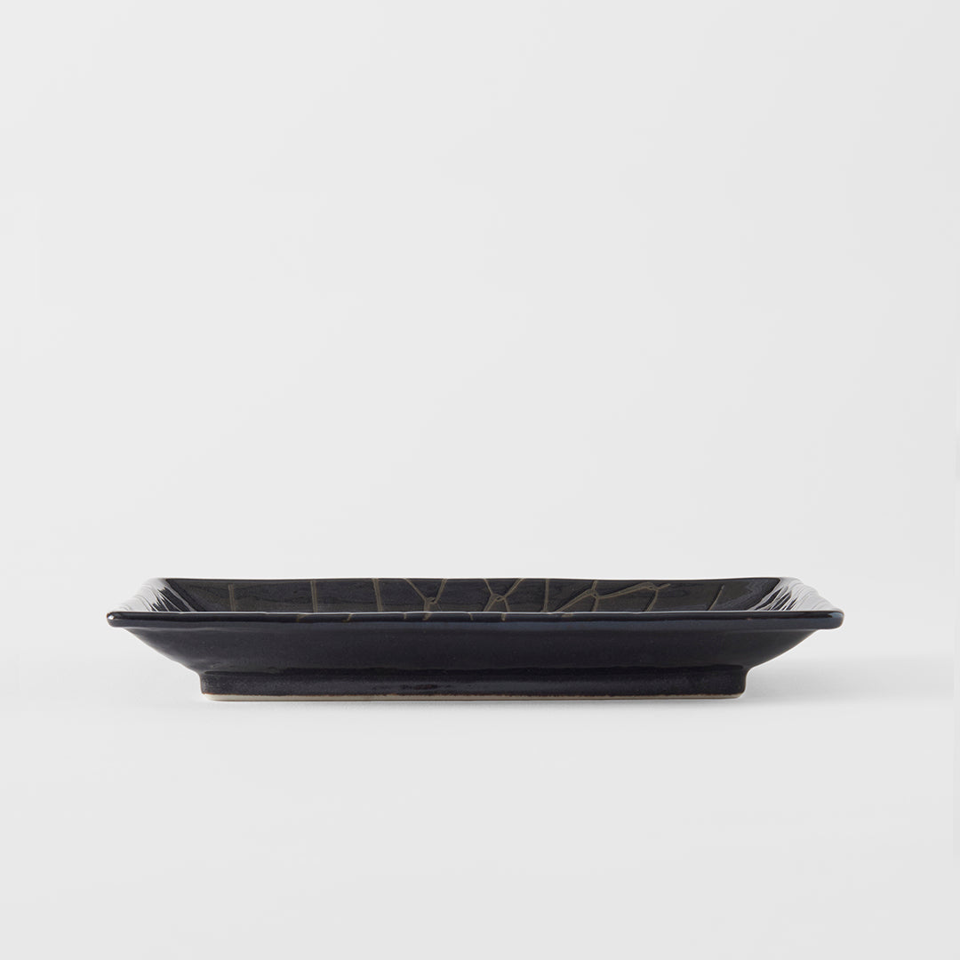Black rectangular plate with geometric design on a white background