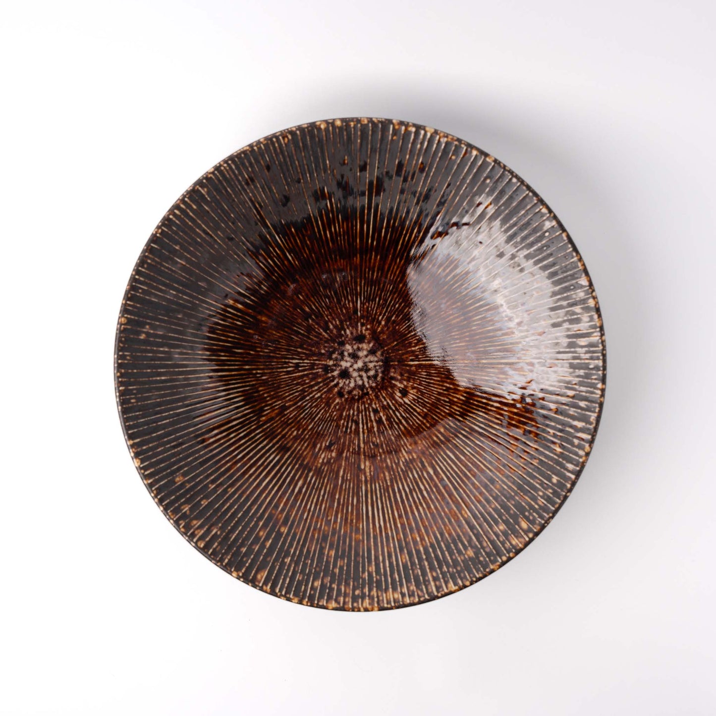 Ceramic plate with textured design on a white background