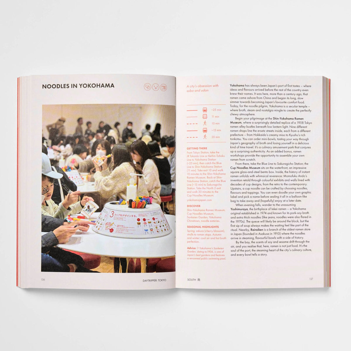 An open book or magazine spread on a light gray background. The left page shows a photograph of people seated around a table with a small round dish or tray in the foreground, under the heading 'NOODLES IN YOKOHAMA.