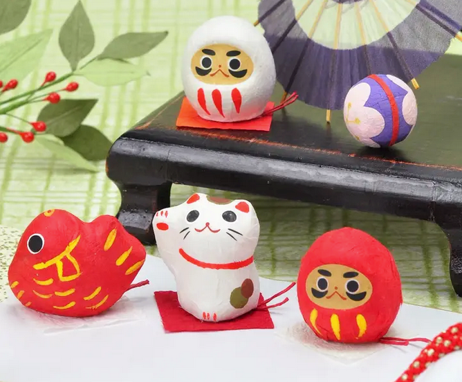 Noted Flowering Fortune Seed Paper Token - Red Daruma