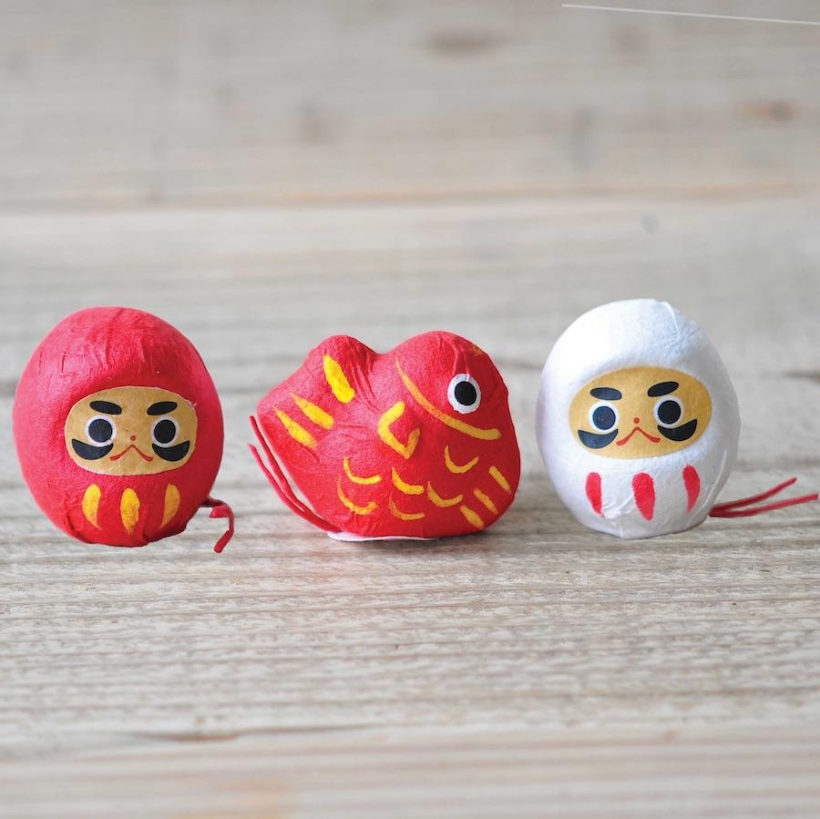 Noted Flowering Fortune Seed Paper Token - Red Daruma