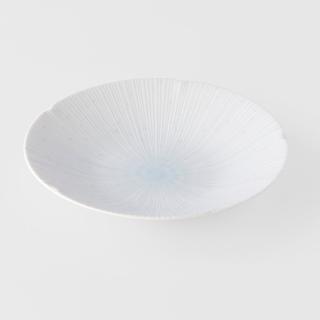 White ceramic plate with textured design on a white background