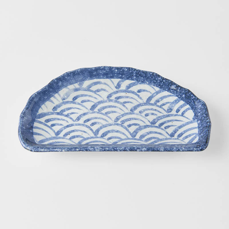 Ceramic tray with wave pattern on a white background