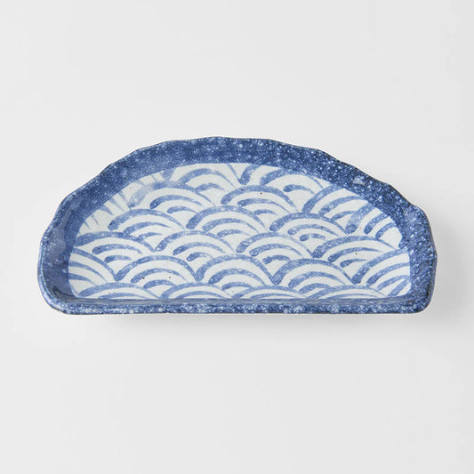 Ceramic tray with wave pattern on a white background