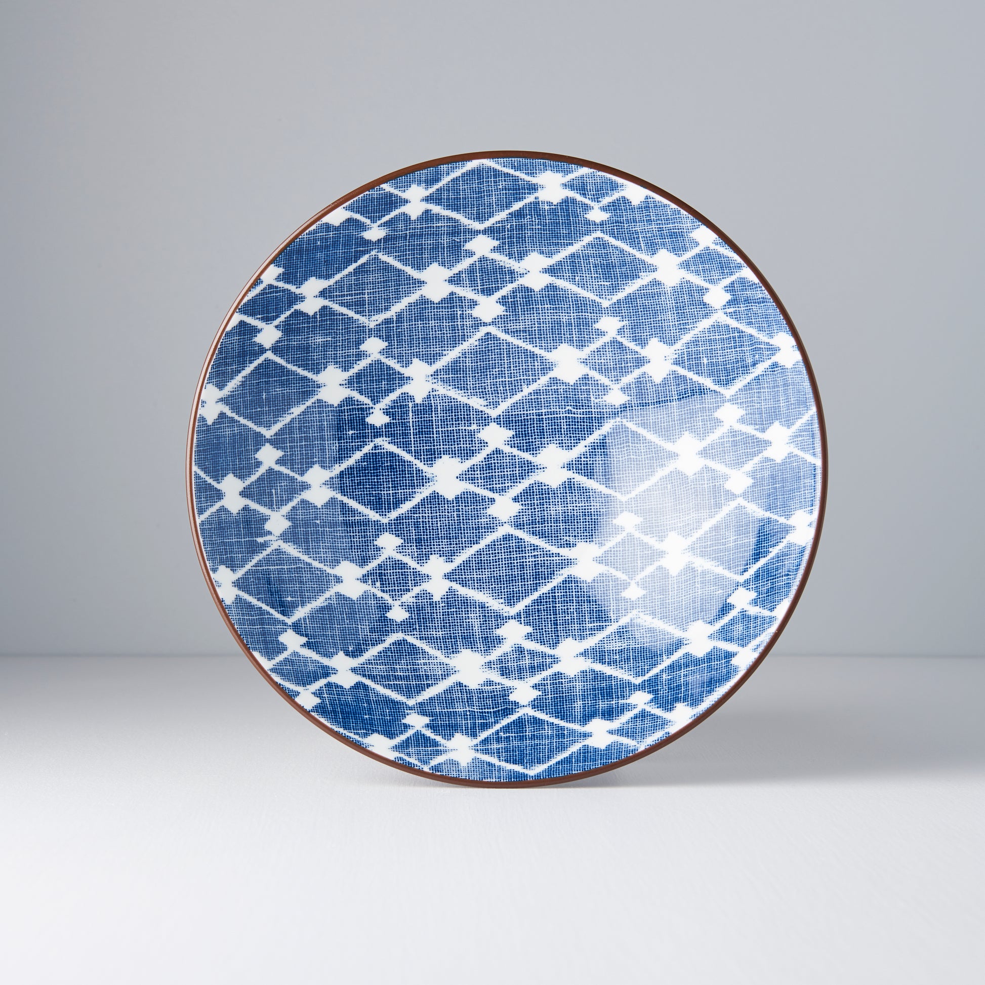 Blue and white patterned plate on a gray background