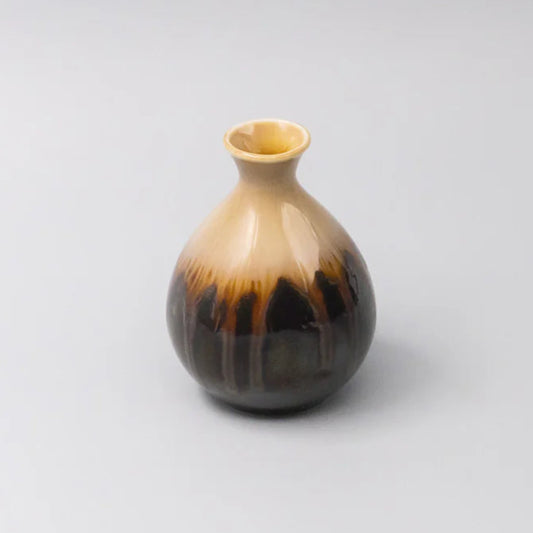 Vase with brown and black gradient on a light gray background
