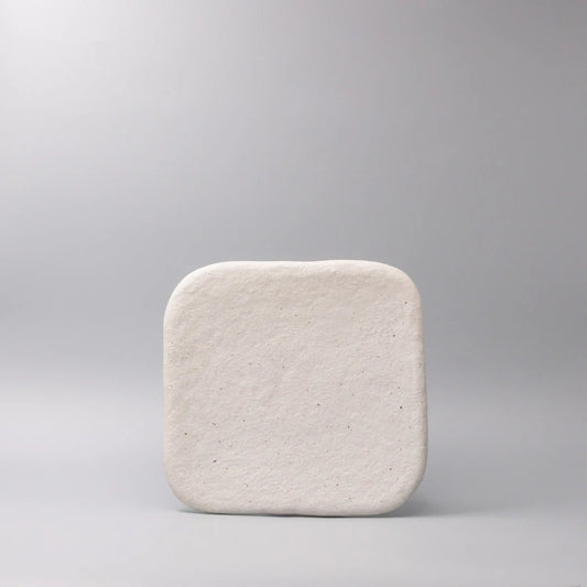 Square ceramic plate on a gray background