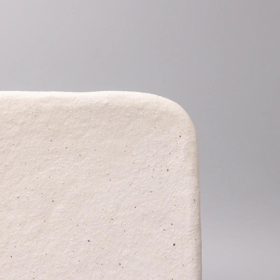 Close-up of a textured white surface against a gray background