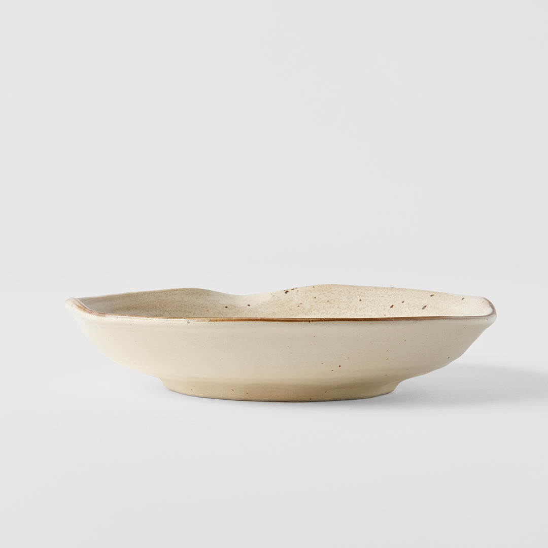Beige ceramic bowl on a light gray background