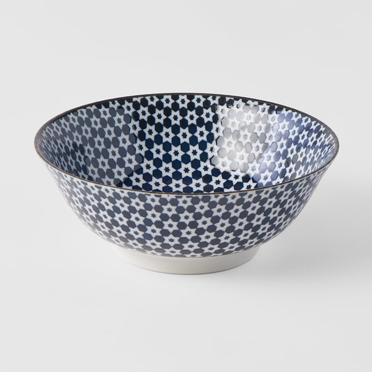 Decorative bowl with blue and white pattern on a light gray background