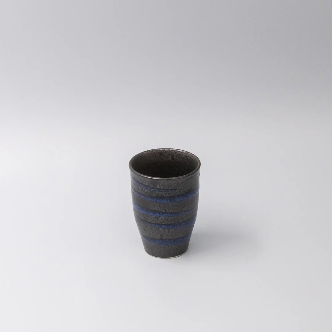 Ceramic cup with blue stripes on a white background
