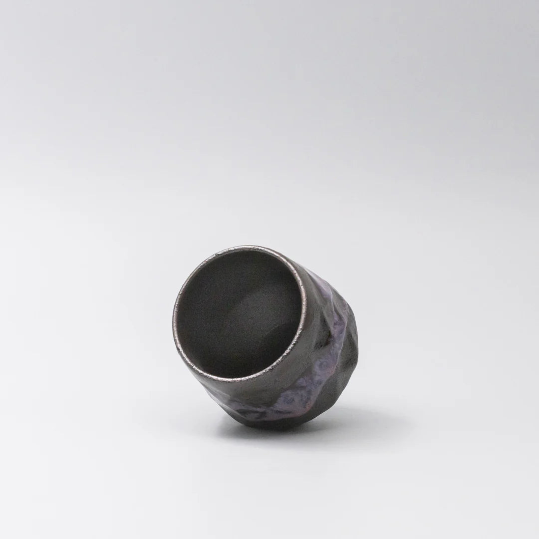 Black ceramic cup on a white background