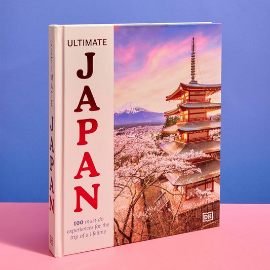 Book titled 'Ultimate Japan' with a cherry blossom and temple design on a pink and blue background