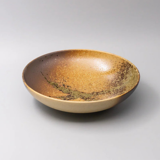 Ceramic bowl with brown and beige glaze on a white background