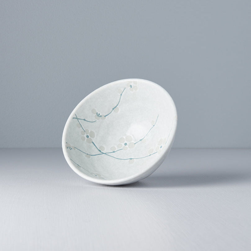 Ceramic bowl with floral design on a gray background