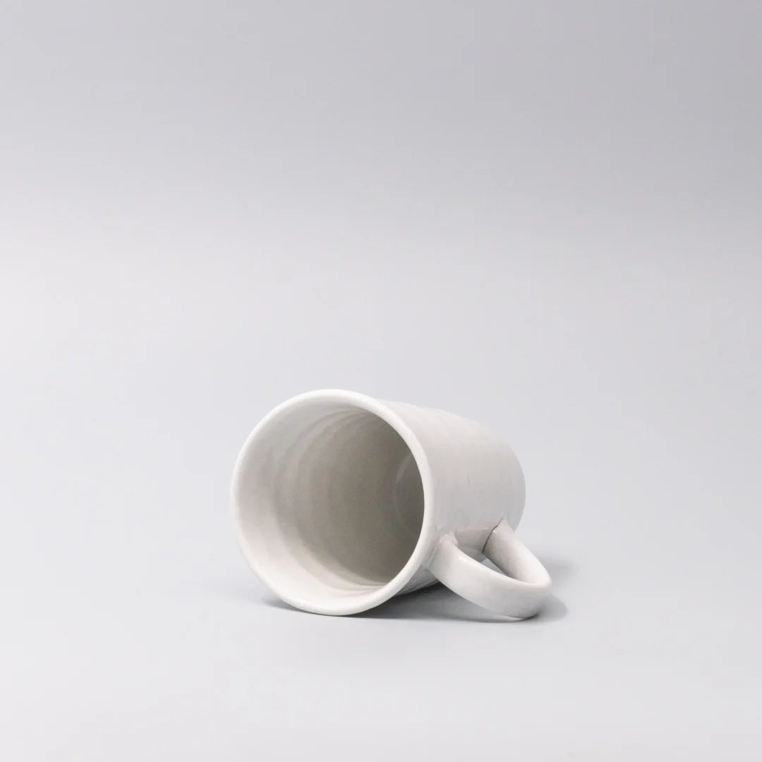 White ceramic mug on a light gray background