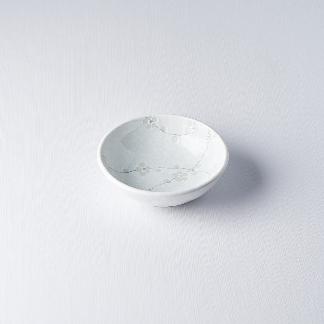 White ceramic bowl with marble-like pattern on a light gray background