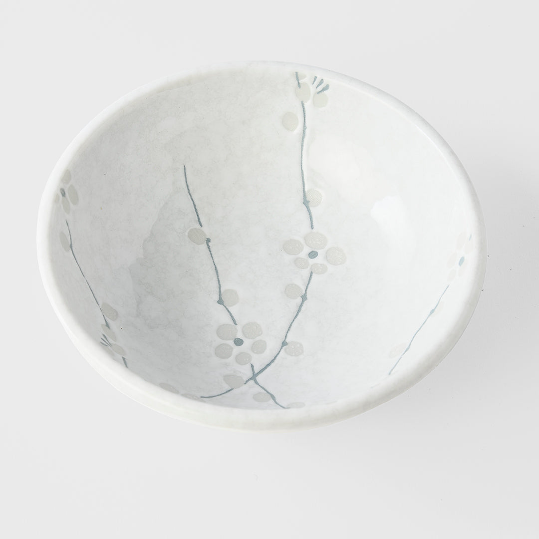 Round ceramic plate with floral design on a white background